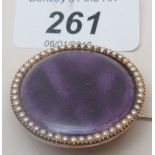 A gold and enamel round brooch surrounded by pearls est: £200-£250