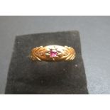 An 18ct gold ring inset with centre ruby and two small diamonds (size L) est: £100-£150