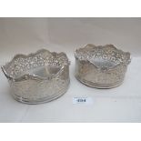 A pair of heavy Victorian silver coasters with pierced decoration of scrolls & flowers,