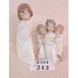 Two Lladro figures, depicting a group of three cherubs singing from a hymn sheet,