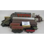 A quantity of old toy railway items to include tin train garage, quantity of track,