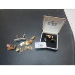 A pair of boxed cuff links,