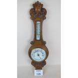 A late Victorian/Edwardian carved light oak cased aneroid barometer/thermometer est: £40-£60 (C)