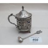 A silver mustard pot and spoon with pierced decoration,