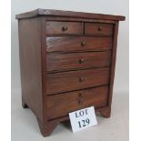 A late Victorian/Edwardian walnut miniature chest, on bracket feet,