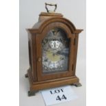 A reproduction Georgian-style oak cased striking bracket clock,