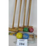 A vintage child's croquet set comprising 4 mallets, 2 stakes,