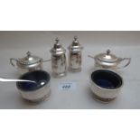 A silver condiment set comprising of two peppers,