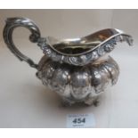 A Georgian Irish silver jug, heavily embossed with acanthus leaf decoration Dublin 1828 (approx 9.