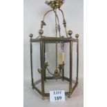 An elegant Georgian-revival brass ceiling lantern, hexagonal form with glass panels,