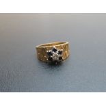 An 18ct gold ring set with centre diamond and blue stone (size N) est: £70-£100