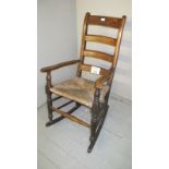 An 18th century Lancashire country rush seated rocking chair est: £50-£100