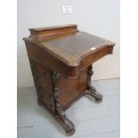 A Victorian walnut inlaid Davenport desk with a tooled leather inset top over four drawers to one