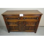 A 20th century oak carved sideboard with two drawers over cupboard doors to base est: £50-£80