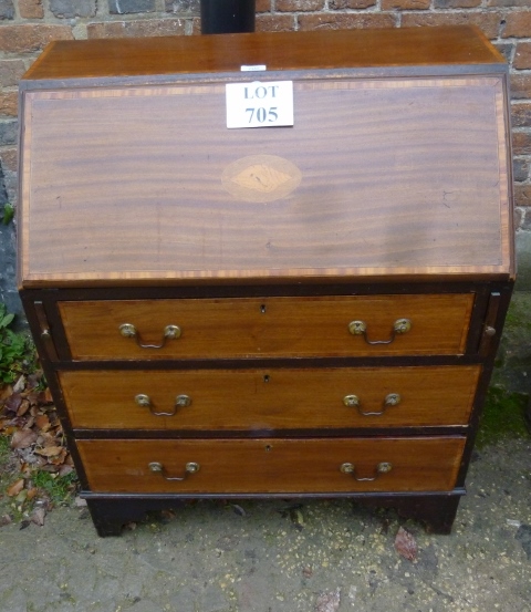 A late 19th century mahogany bureau with fitted interior over three drawers and with shell inlay