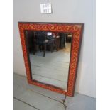 A decorative red and gilt painted wall mirror est: £30-£50