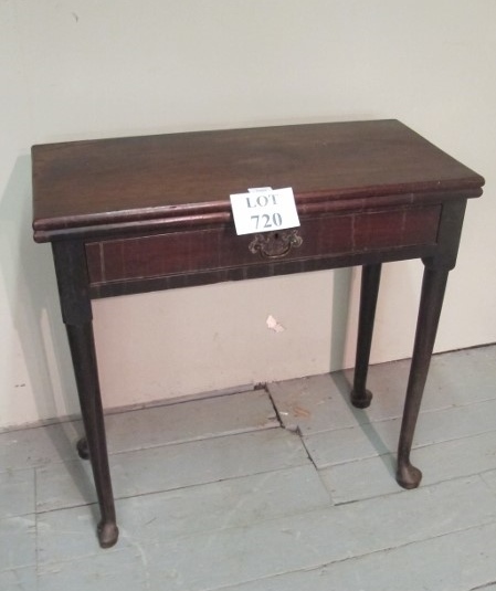 A Georgian mahogany tea table with a centre drawer and terminating on pad feet est: £350-£450