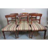 A set of six mahogany framed Victorian dining chairs upholstered in stripe material and terminating