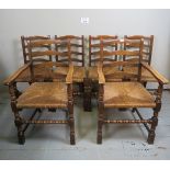 A set of six 20th century oak framed dining chairs with rush seats and turned supports.