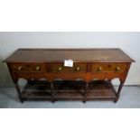 A fine oak dresser base with three drawers to top,