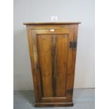 A 19th century pine cupboard with a single door revealing three interior shelves and with iron