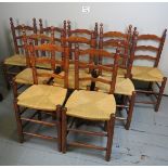 A harlequin set of ten rush seated ladder-back dining chairs with turned finial's est: £100-£150