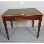 A 20th century Edwardian design mahogany writing table with inset tooled green leather top over a