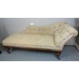 A Victorian mahogany framed chaise lounge upholstered in cream floral buttoned material and