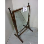 A 19th century mahogany toilet mirror with turned finial's and supports and brass adjusting knobs