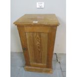 A 20th century pine pot cupboard with a panelled door revealing an interior shelf est: £25-£45