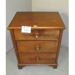 A pretty Victorian bedside chest of three long graduated drawers with turned handles with inset
