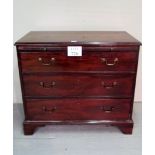 A 19th century mahogany bachelor's chest with brushing slide over three long drawers with brass