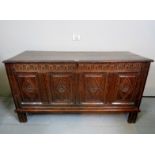 A 19th century oak panelled coffer with carved frieze and complete with interior candle-box est: