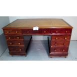A fine Victorian mahogany partner's desk with a tooled tan leather top over three drawers and each