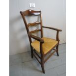 A late 19th century oak framed country rush seated elbow chair est: £30-£50