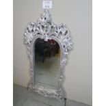 A 20th century elaborately carved and silver painted wall mirror est: £30-£50