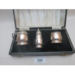 A silver three piece condiment set with