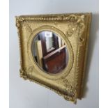 A small gilt framed embossed wall mirror