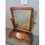 A small pine toilet mirror on a serpenti