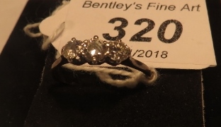 A three stone diamond set ring (size M)