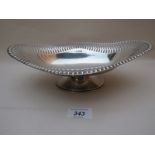 A silver pedestal oval dish with pierced