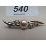 A cubic/zirconia and pearl bar brooch es