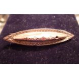 A 9ct gold bar brooch inset with seed pe