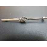 An 18ct three stone diamond bar brooch e