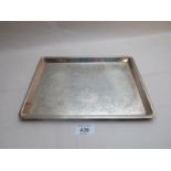 A silver dressing table tray with flower