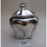 A silver bomb shaped tea caddy with fan