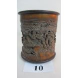 An antique Chinese carved bamboo brush pot, bears carved character marks, flared rims, three feet,