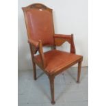 An Arts & Crafts oak elbow chair upholstered back,