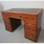 A Victorian mahogany pedestal desk with inset green tooled leather,