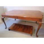 A 20th century mahogany extending dining table with quarter veneer and beaded top, over pad feet,